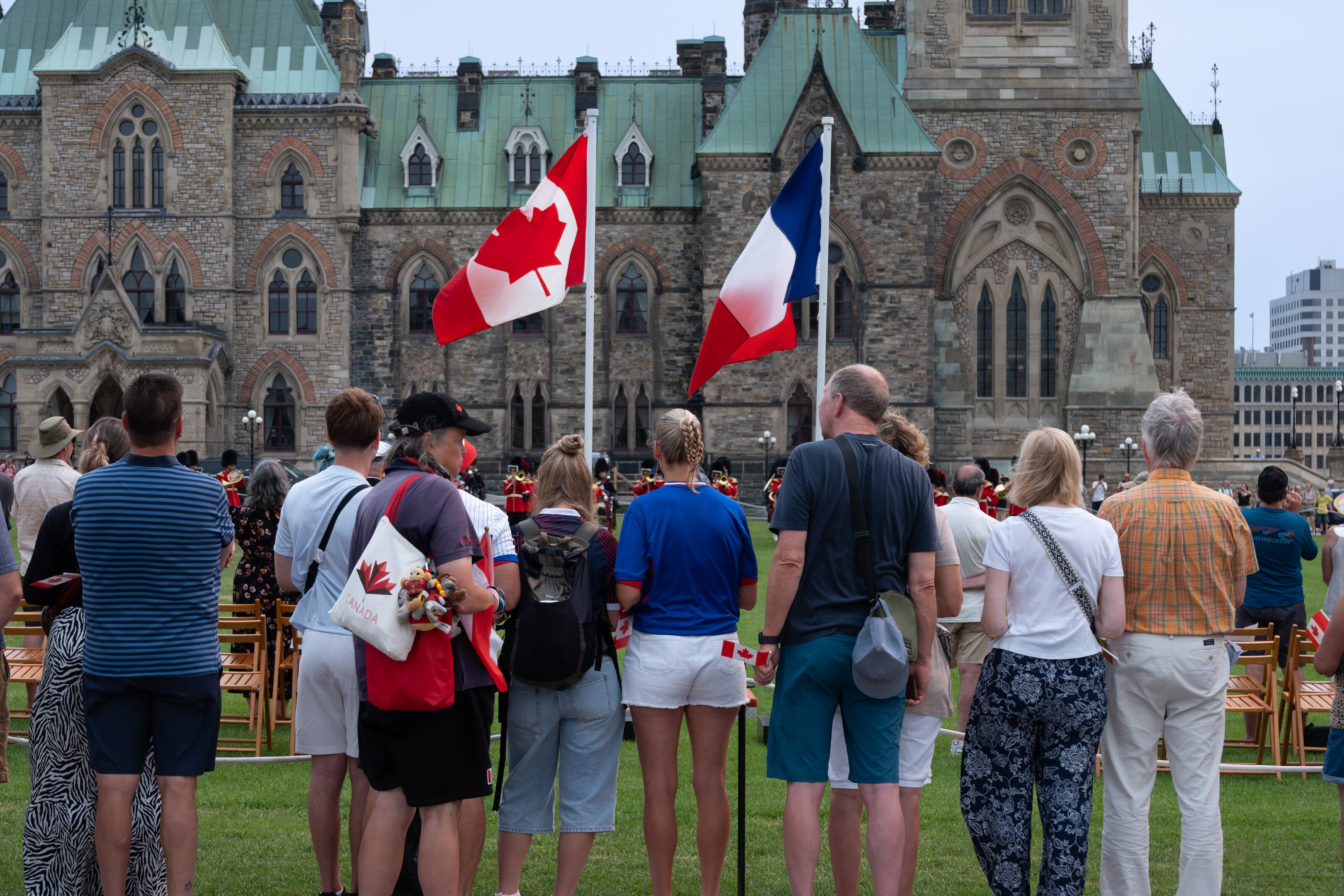 Visitors gathered beneath Canadian flags on Parliament Hill