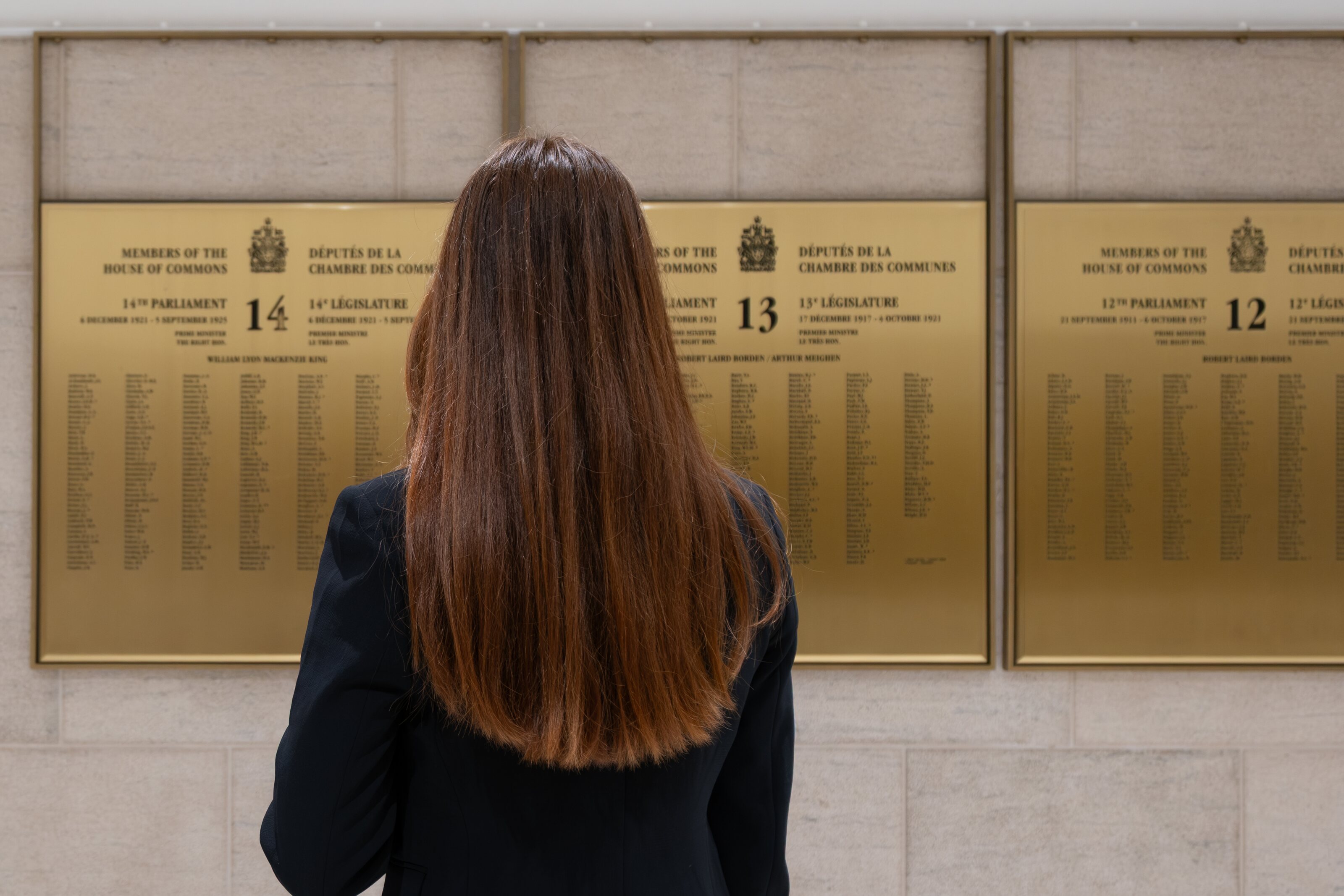 A visitor reading the names recorded on parliamentary walls