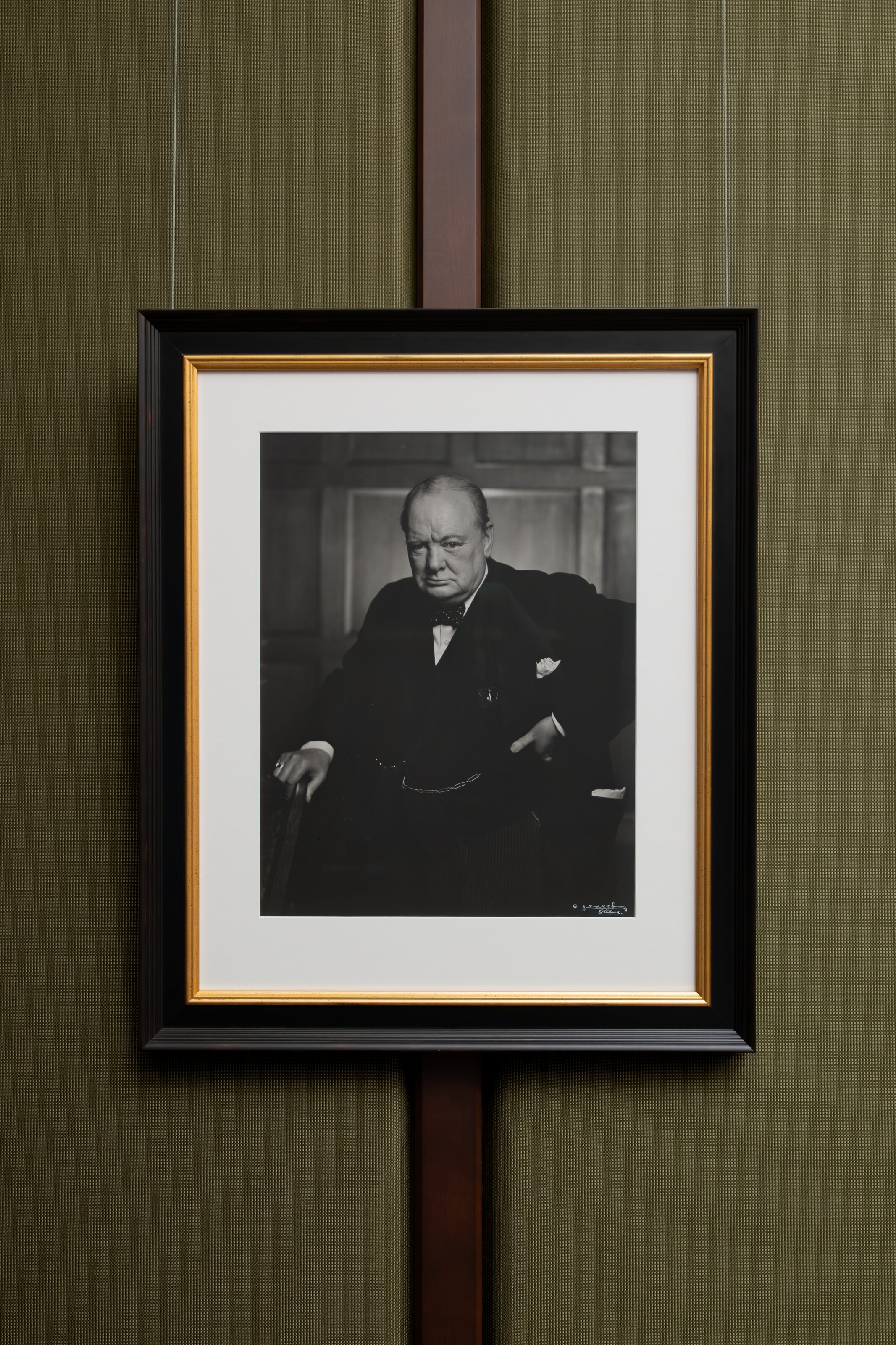 A framed parliamentary portrait on a panelled wall