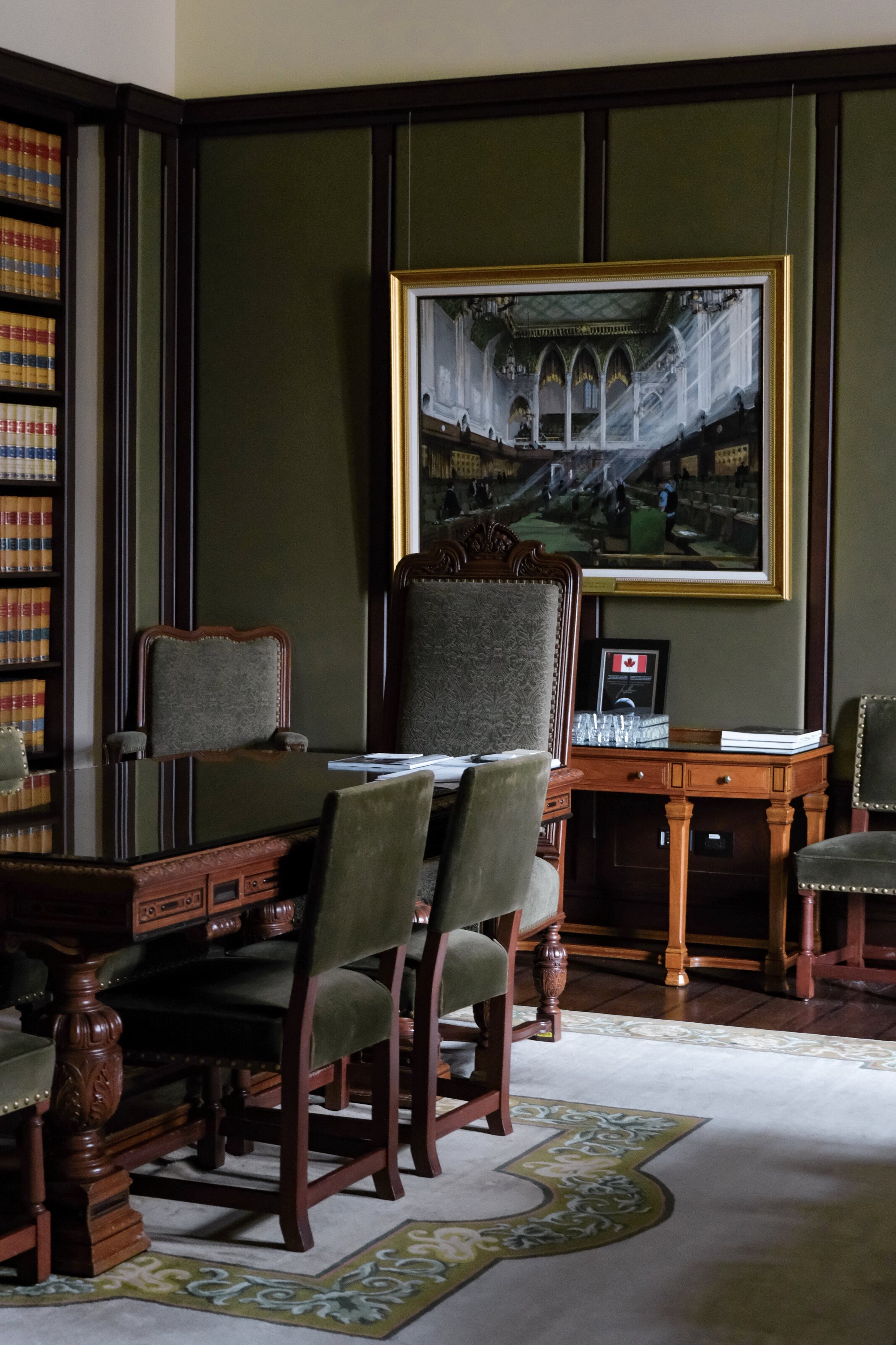 A formal parliamentary office with desks and chairs