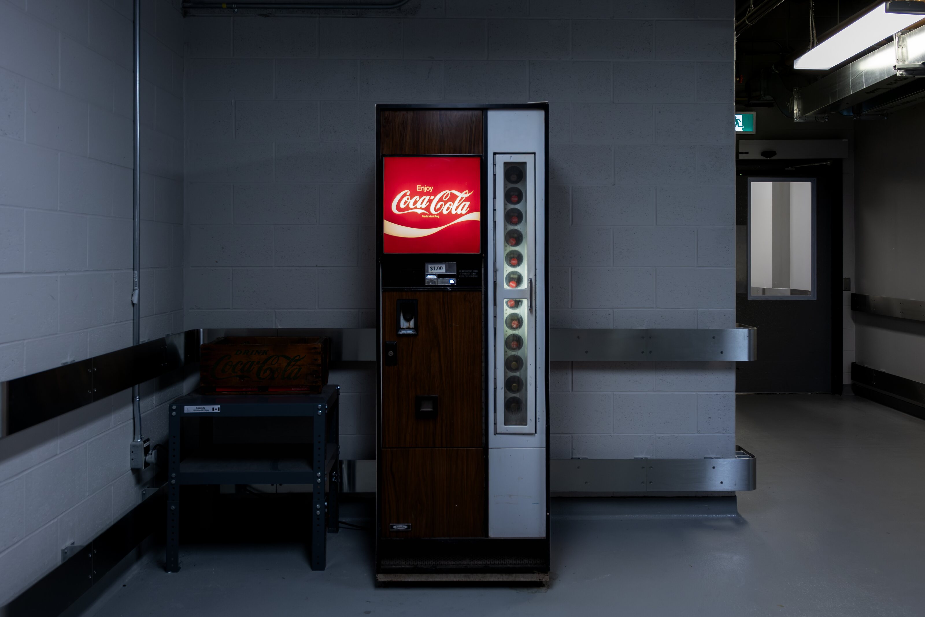 A glowing Coca-Cola machine in a Parliament corridor