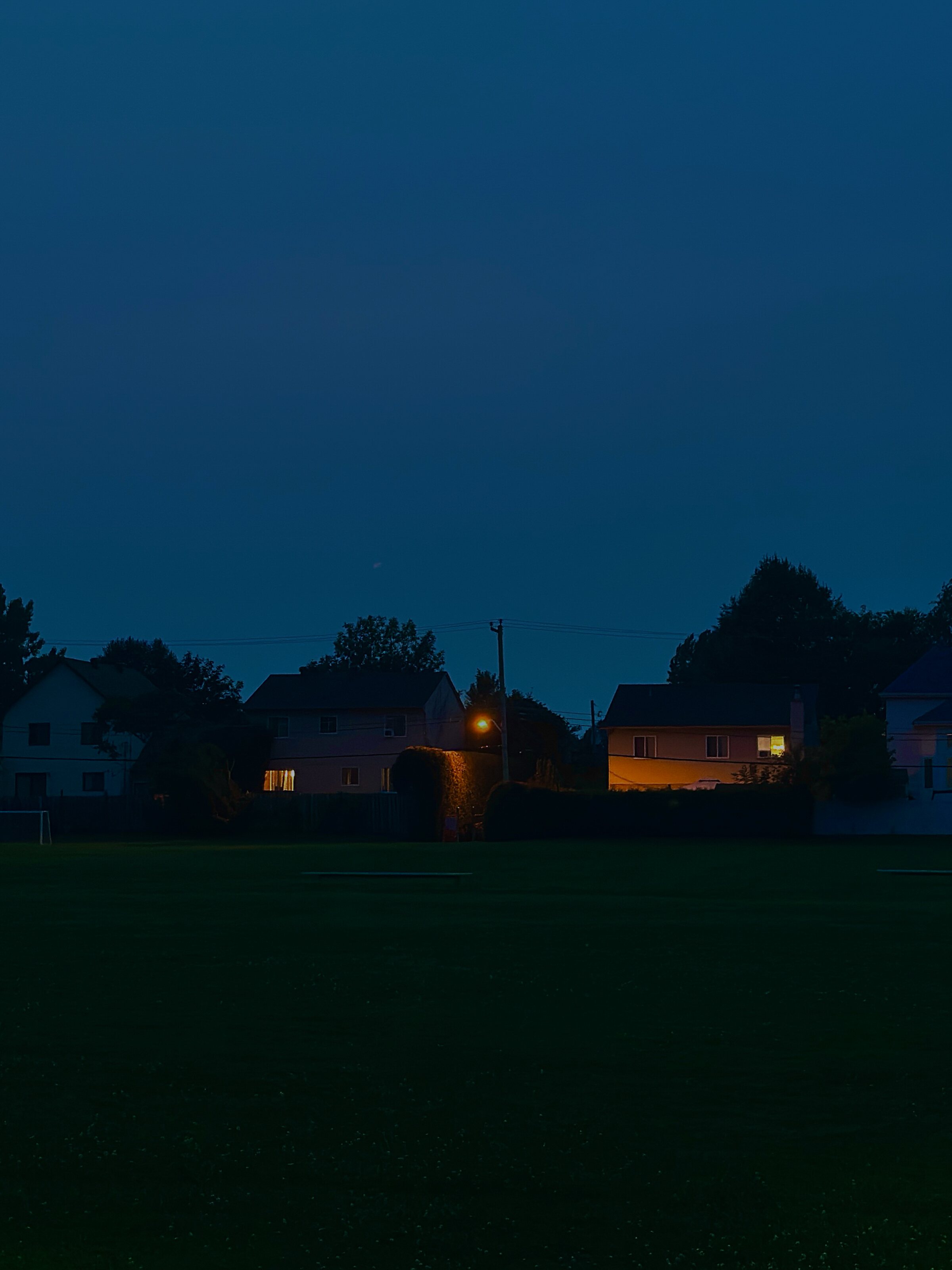 Suburban houses and scattered lights at blue hour